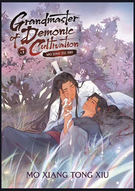 Grandmaster of Demonic Cultivation volume five cover with two figures lying in grass beneath lavender blossoms