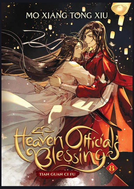 Heaven Official's Blessing volume eight cover with a figure in red robes embracing a figure in white beneath floating lanterns, gold title lettering