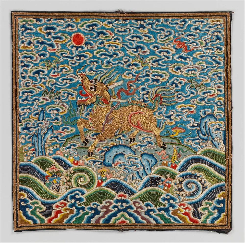 Embroidered Qing dynasty rank badge with a golden qilin rearing on a rock above stylized waves, under a red sun and swirling clouds